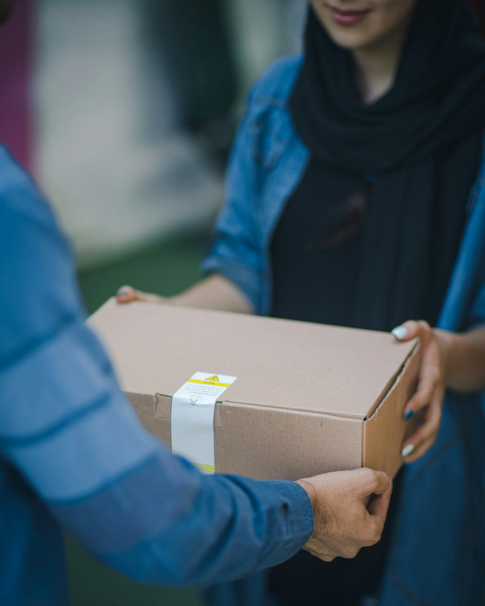 Handing a parcel to a customer