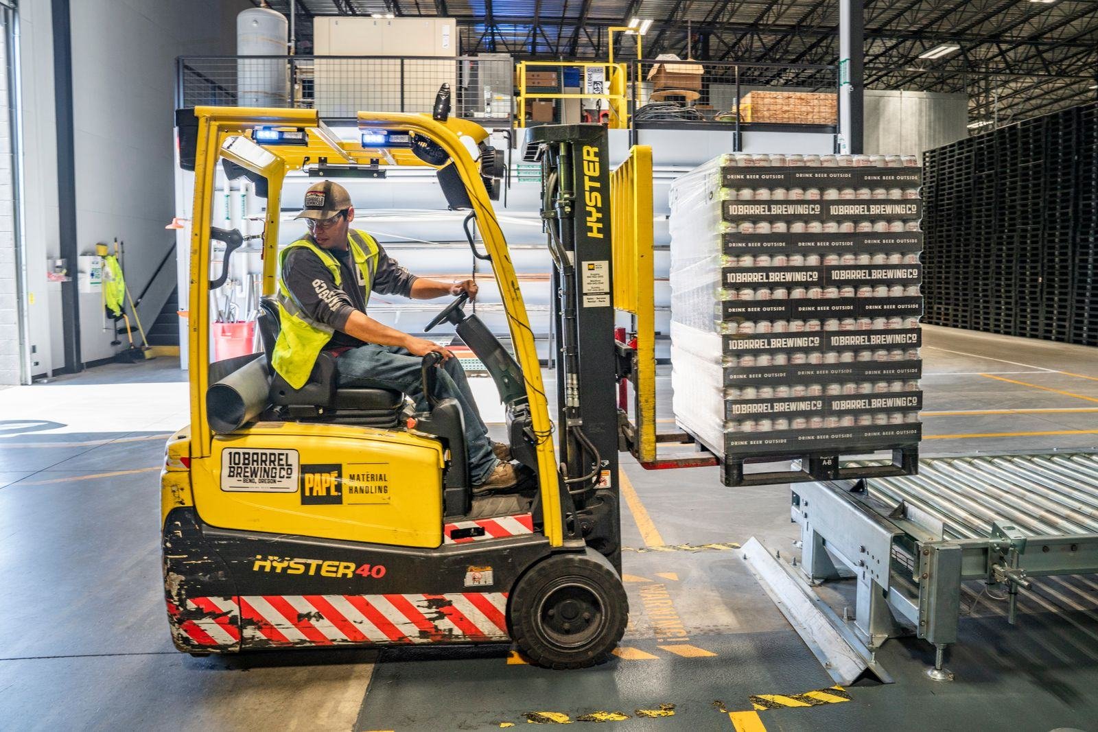 Forklift moving pallets inside a warehouse